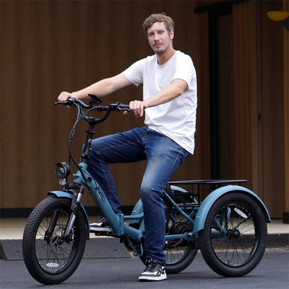 Fafree's F20 Mate - 48V 21Ah electric tricycle standing outside with a man driving it